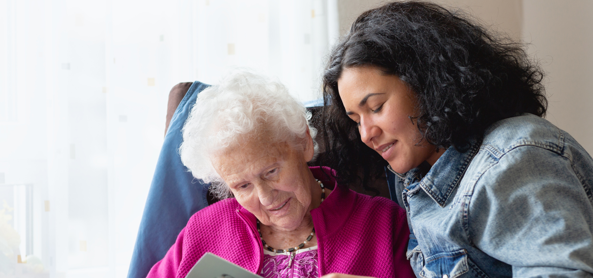 Senior woman with daughter looking at tablet